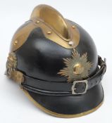 An early 20th century German black leather fire helmet: the skull with attached gilt brass comb and