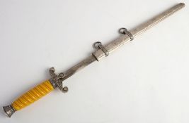 A reproduction Luftwaffe dagger: the double edged blade over eagle hilt and one piece grip with