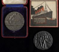 Two WWI Lusitania Medallions: one in original box the other in an associated case (2)