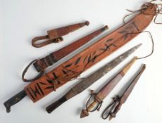A Columbian Garza machete: with two piece wooden grip in a fringed leather scabbard,