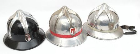 Three Austrian Fire Service aluminium helmets: all with six pointed comb and enamel badges to front,