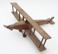 A scratch built wooden model of a biplane: with RAF roundels to wings and fuselage,