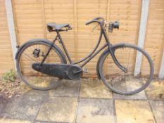 A 1914 Sunbeam lady's bicycle: the black step through frame with shaped bars and bar brakes,