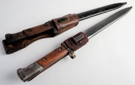 Two Czechoslovakian V224 pattern bayonets: both with two piece wooden grips in steel scabbards,