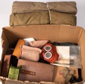 A collection of various militaria: including gas masks, field dressings,