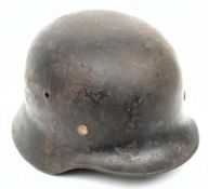 A WWII German M35 steel helmet: with rolled rim,