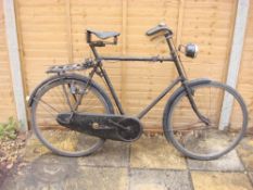 A 1920s Sunbeam bicycle: frame mounted Sturmey Archer three speed gears, bar brakes, leather saddle,
