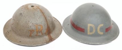 A WWII Mk II District Council steel helmet: the grey shell with white 'DC' front and back with