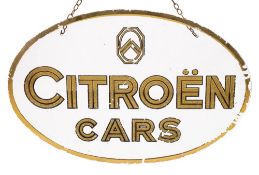 An oval glass 'Citroen Cars' dealership advertising sign: the gilt logo and text within a gilt