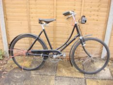 A 1930s Hercules lady's bicycle: black step through frame, solid bar brakes,