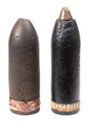 Two WWI artillery shells: one with brass fuse.