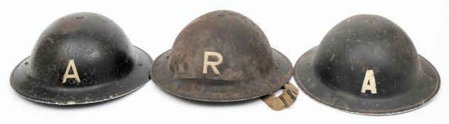 Two WWII Ambulance Service Brodie pattern steel helmets: one date stamped 1939,