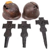 Three WWI Allied forces cast iron grave markers: together with two battlefield relic German helmets.