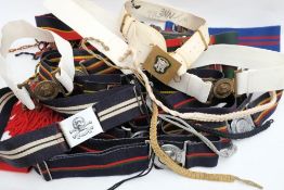 A collection of various British stable belts and aiguillettes: including Royal Pioneer Corps and
