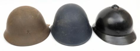 A post war period Japanese steel helmet: together with a Finnish steel helmet and one other
