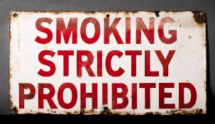 An enamel warning sign 'Smoking Strictly Prohibited': red text on a white ground,