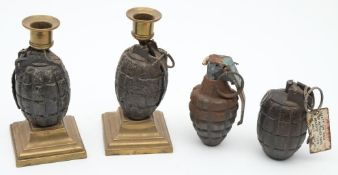 A pair of Mills hand grenade converted to candlestick: with brass sconces and raised on square bras