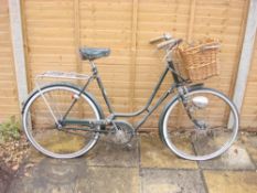 A 1960s BSA Shopper bicycle: green step through frame ,chrome plated handlebars, bar rakes,