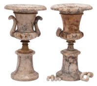 A pair of 19th century alabaster urns: of neo-classical outline, with loop handles to the sides,