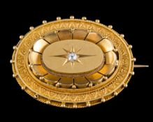A late Victorian diamond brooch: the oval brooch with lobed and bead detail,