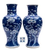 A matched pair of Chinese blue and white baluster vases: painted with prunus on a cracked ice