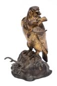 A late Victorian gilt brass desk stand: in the form of a bird of prey with captured bird,