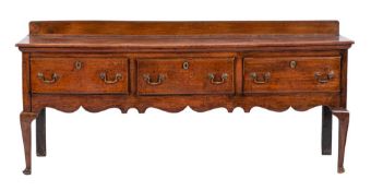 An 18th Century oak rectangular dresser base:, with a ledge back,