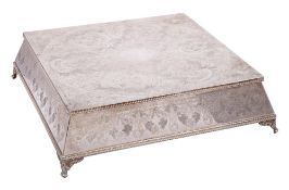 A silver plated wedding cake stand: of square outline with engraved garland,