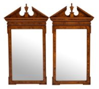 A pair of contemporary yew-wood veneered architectural mirrors:, with moulded broken pediments,