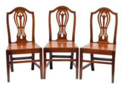 A set of six George III oak dining chairs: in the Hepplewhite taste,