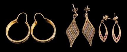 A pair of yellow metal hoop earrings: a pair of three colour drop earrings and a pair of ruby