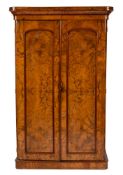 A Victorian figured walnut wardrobe:, with a moulded cornice,