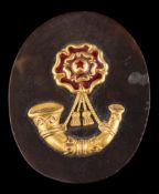A tortoiseshell and enamel Light Infantry military badge/brooch: the oval tortoiseshell panel with