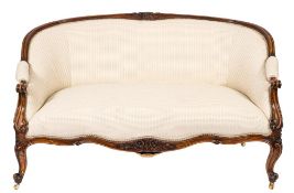 A 19th century carved walnut twin seat settee in the French taste:,