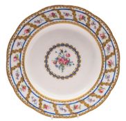 A Sevrès soup plate [assiette à potage]: painted with a central rose and cornflower medallion