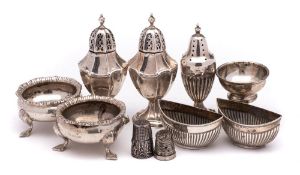 A mixed collection of silver condiments, various makers and dates: includes salts, peppers,