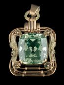 A synthetic green spinel mounted pendant: the cushion-shaped spinel 20mm x 18mm within an openwork