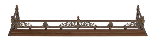 A brass rectangular fender:, with turned finials,