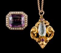 An aquamarine and ruby pendant: the pear cut aquamarine between two cushion cut rubies,