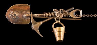 A gold miner's bar brooch: in the form of a shovel and axe, approximately 4.5g gross weight.