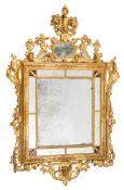 An early 19th Century carved giltwood rectangular marginal wall mirror:, surmounted by flowerheads,
