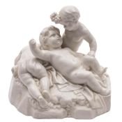 A Frankenthal white group of three cherubs: one holding a bunch of grapes above another,