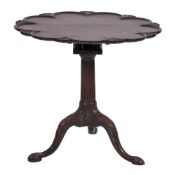 A George III mahogany tea table:, the lobed circular snap top with carved shell and moulded border,