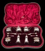 An Edward VII silver condiment set, maker Adie Bros Ltd, Chester 1908: includes four salts,
