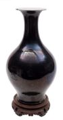 A Chinese mirror-black glazed vase and a celadon glazed vase: the first of baluster form with