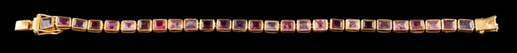 A garnet bracelet: the rectangular cut garnets in collet settings, to the clasp (broken), 17cm long.