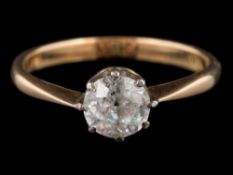 A zircon single-stone ring: the circular cut zircon in a claw setting, the shank stamped '18ct',