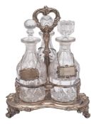 A late Victorian plated three-bottle decanter stand: of trefoil outline with central waisted stem