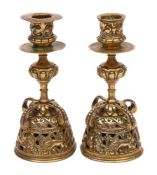 A pair of Dutch 17th century-style brass candlesticks: with foliate decorated sconces on knopped