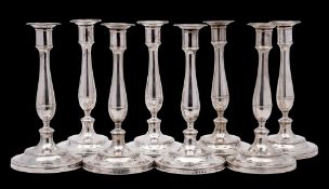 A fine set of eight George III silver candlesticks, maker Robert Garrard I, London,